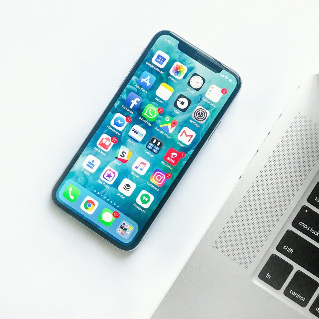 Hand holding smartphone with apps